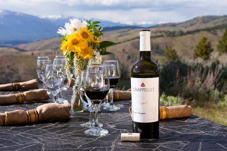 wine and flowers on outside table